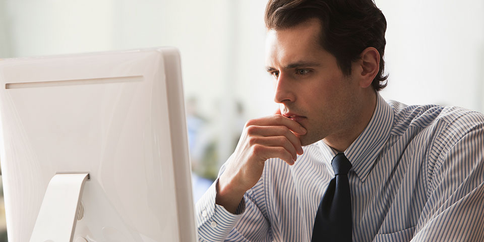 Man looking at computer screen attentively